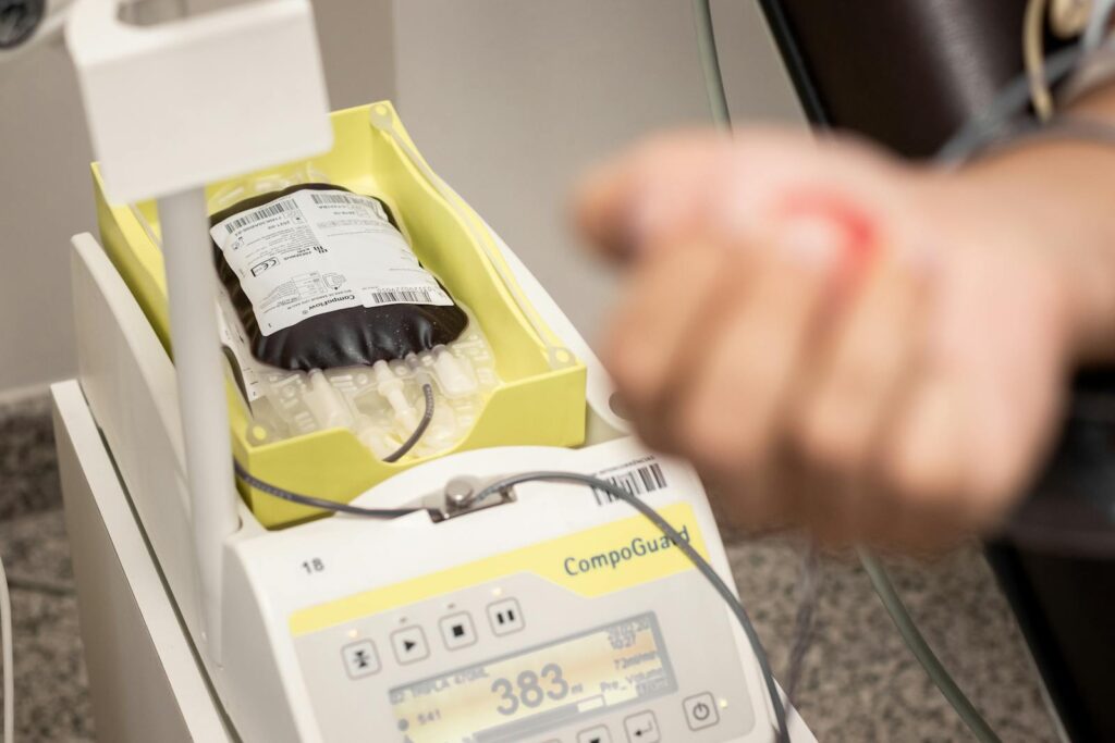 Close-up of blood collection equipment during a donation process in a medical facility.