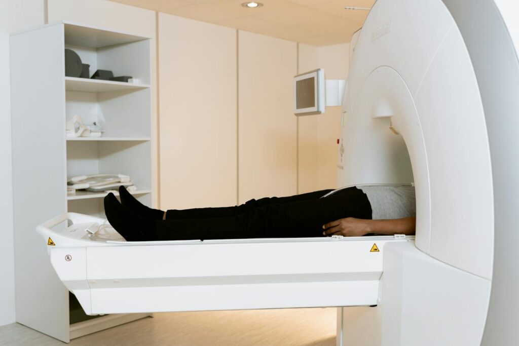 A patient is lying down inside an MRI machine during a scan at a healthcare facility.